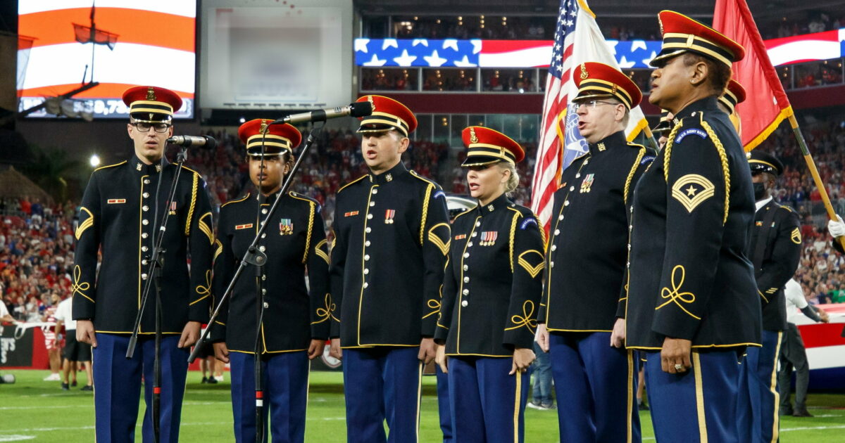 Vocalists from each military branch perform the national anthem