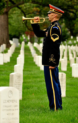 A bugler from The U.S. Army band performing at Arlington National Cemetery
